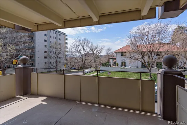 a room with lots of white furniture a window and a sink