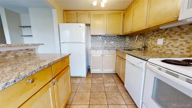 a kitchen with a sink a stove top oven and cabinets