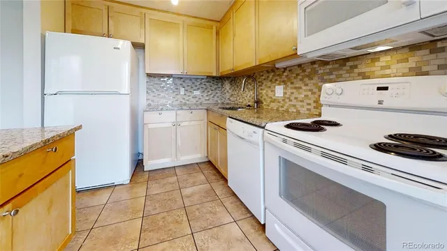 a kitchen with a stove top oven and cabinets