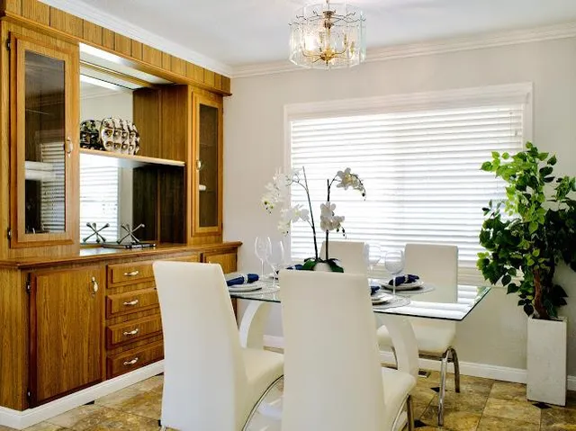 a view of a dining room with furniture and a potted plant