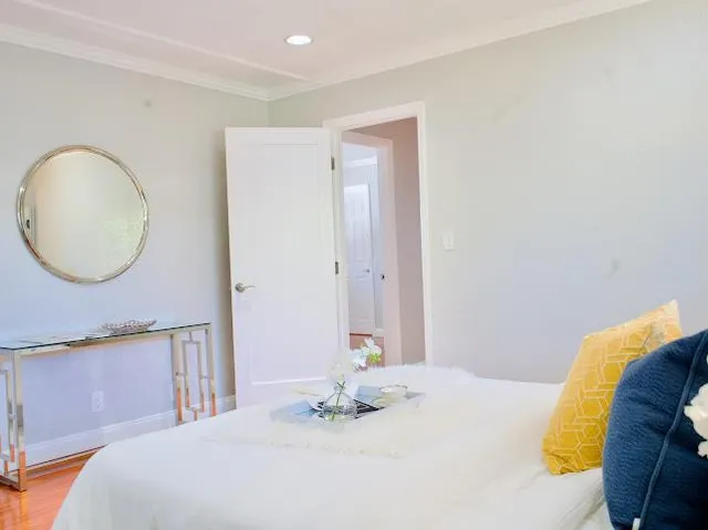 a bedroom with a bed and a mirror