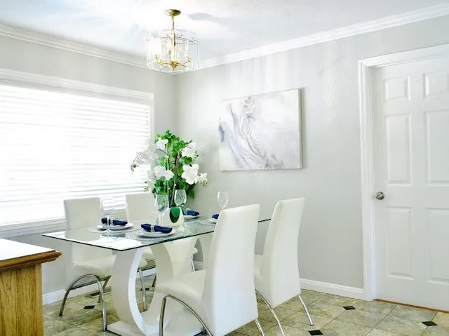 a view of a dining room with furniture and chandelier