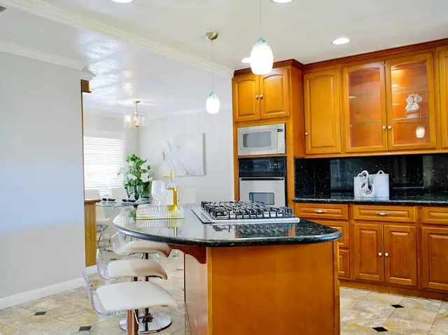 a kitchen with stainless steel appliances granite countertop a sink and a stove