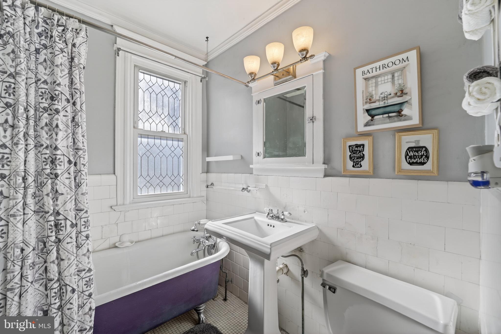 4301 4th Street Northwest Washington, DC 20011 - Photo 41 of 64 a bathroom with a sink a toilet a mirror a window and a shower