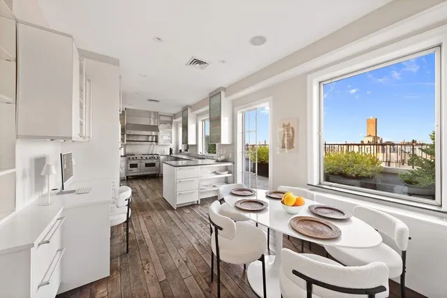 a kitchen with a refrigerator a stove and a wooden floor
