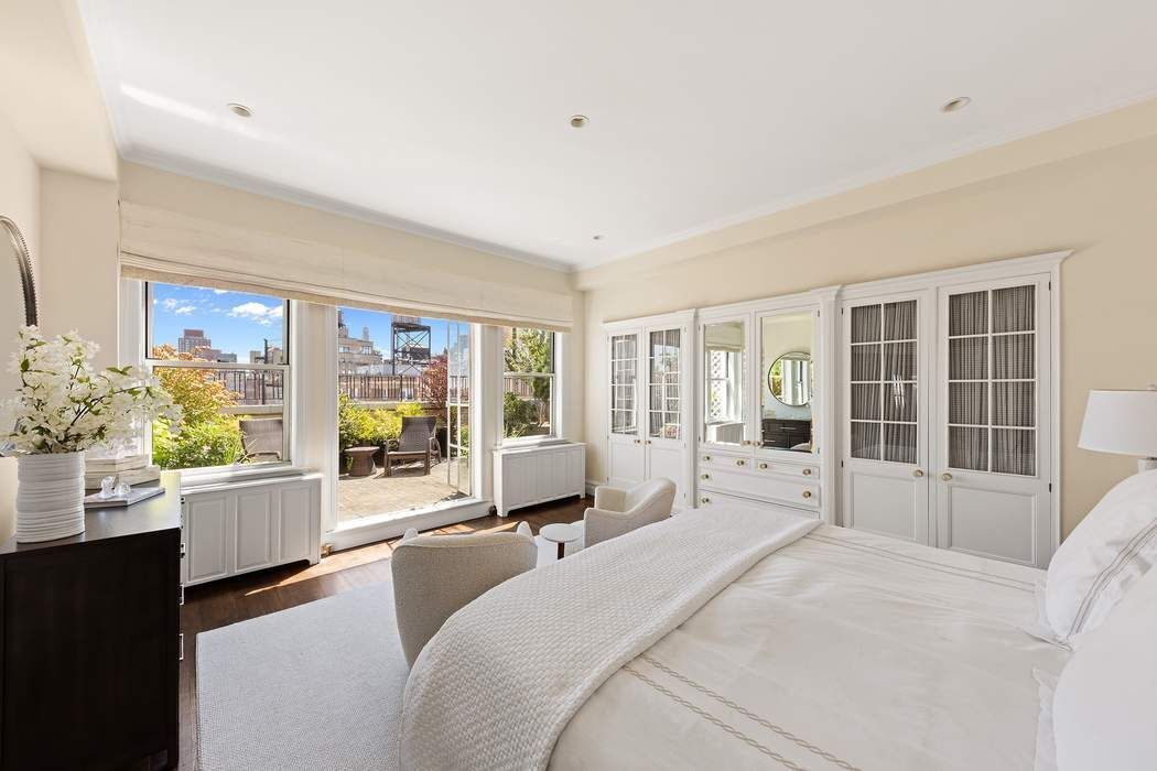 1158 5th Avenue, Unit PHC Manhattan, NY 10128 - Photo 10 of 25 a large bedroom with a large bed and large windows