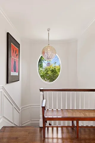 a bathroom with a sink toilet a mirror and window