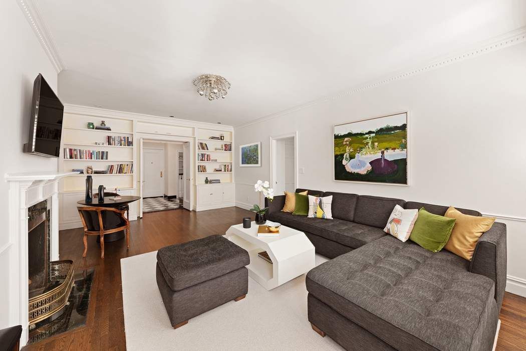 1158 5th Avenue, Unit PHC Manhattan, NY 10128 - Photo 14 of 25 a living room with furniture and a flat screen tv