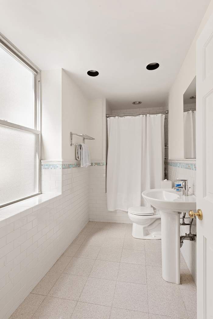 1158 5th Avenue, Unit PHC Manhattan, NY 10128 - Photo 16 of 25 a large white kitchen with a white countertops and cabinets