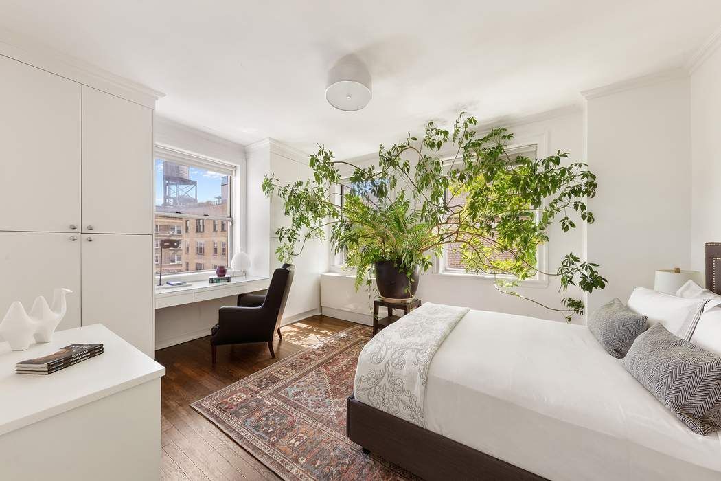 1158 5th Avenue, Unit PHC Manhattan, NY 10128 - Photo 17 of 25 a bedroom with a bed table flowerpot and window
