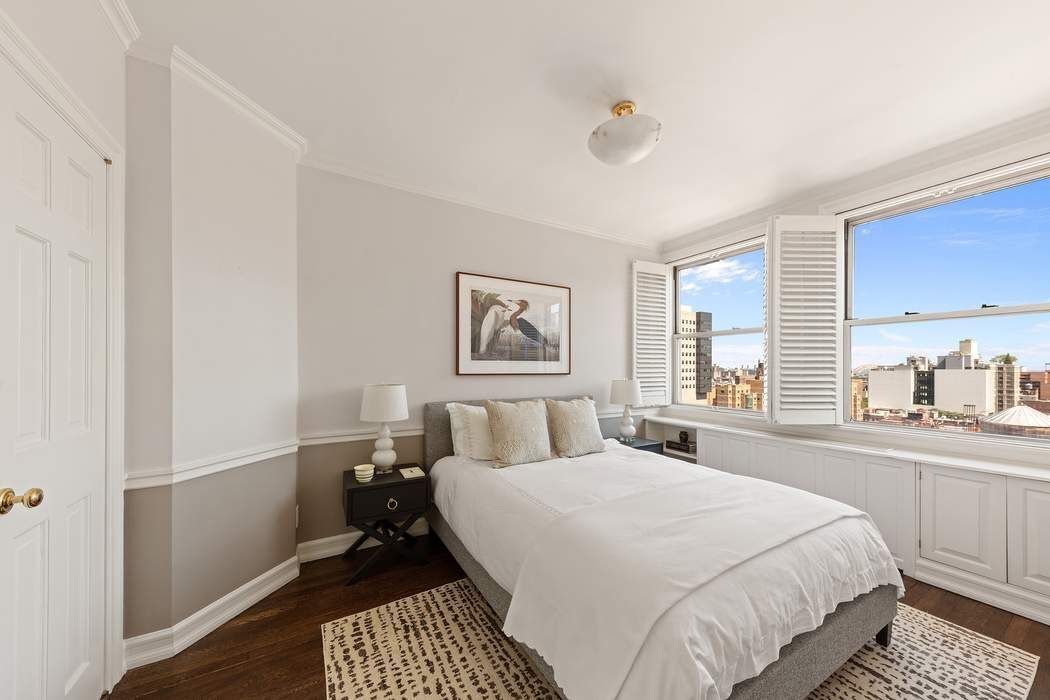 1158 5th Avenue, Unit PHC Manhattan, NY 10128 - Photo 18 of 25 a bedroom with a bed and a window