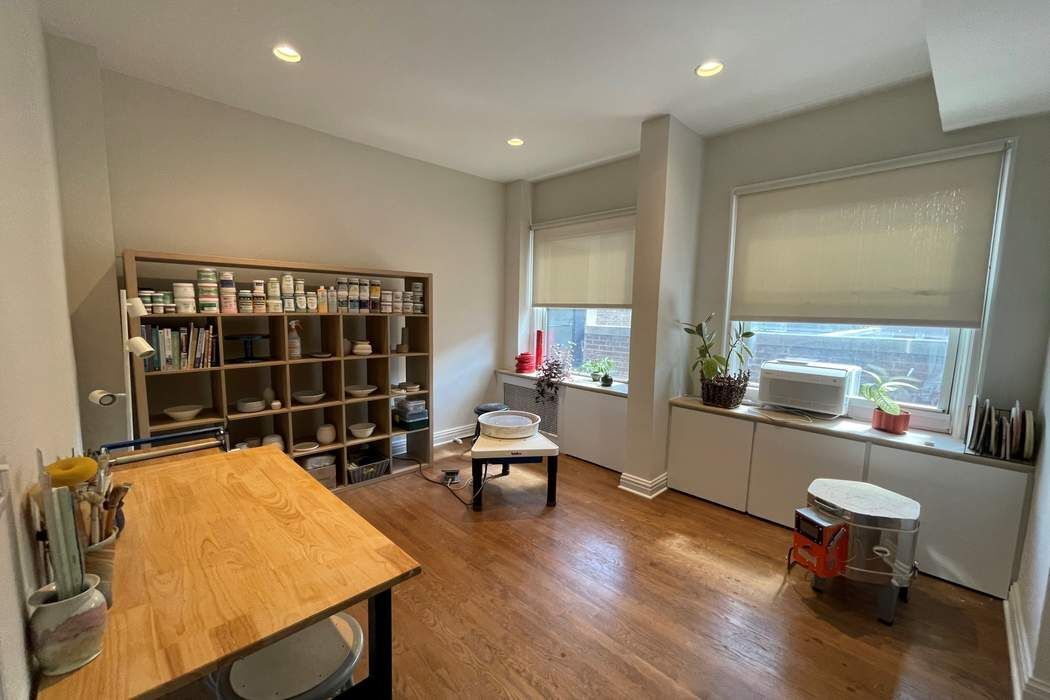 1158 5th Avenue, Unit PHC Manhattan, NY 10128 - Photo 21 of 25 a room with furniture pool table wooden floor and windows