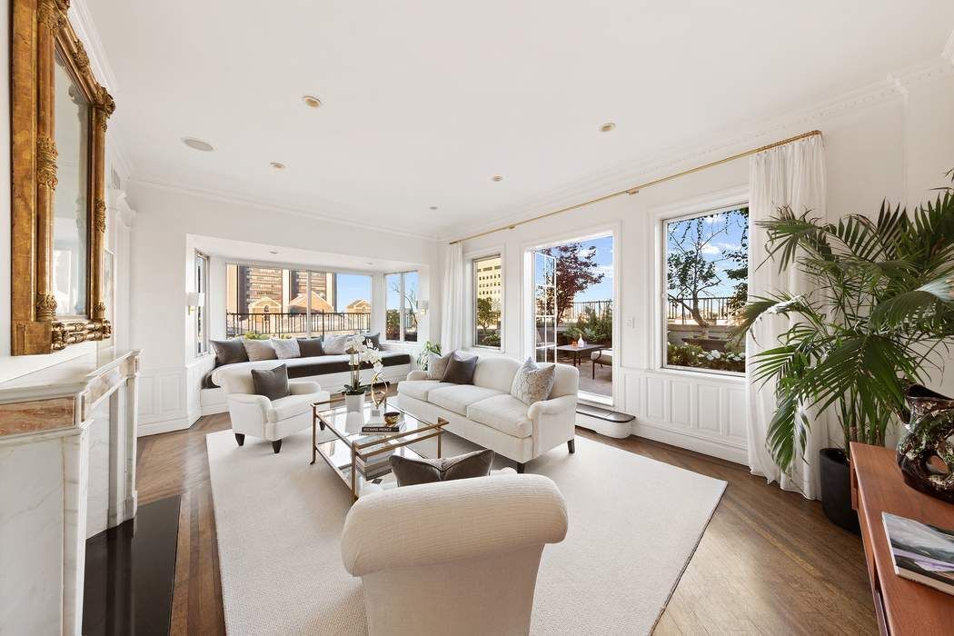 1158 5th Avenue, Unit PHC Manhattan, NY 10128 - Photo 5 of 25 a living room with furniture potted plant and a large window