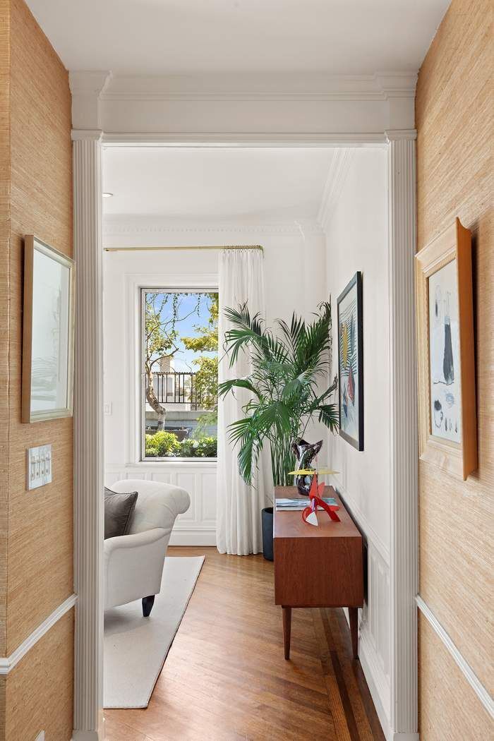 1158 5th Avenue, Unit PHC Manhattan, NY 10128 - Photo 6 of 25 a living room with furniture and a potted plant