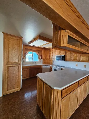 a kitchen with a sink a refrigerator and cabinets