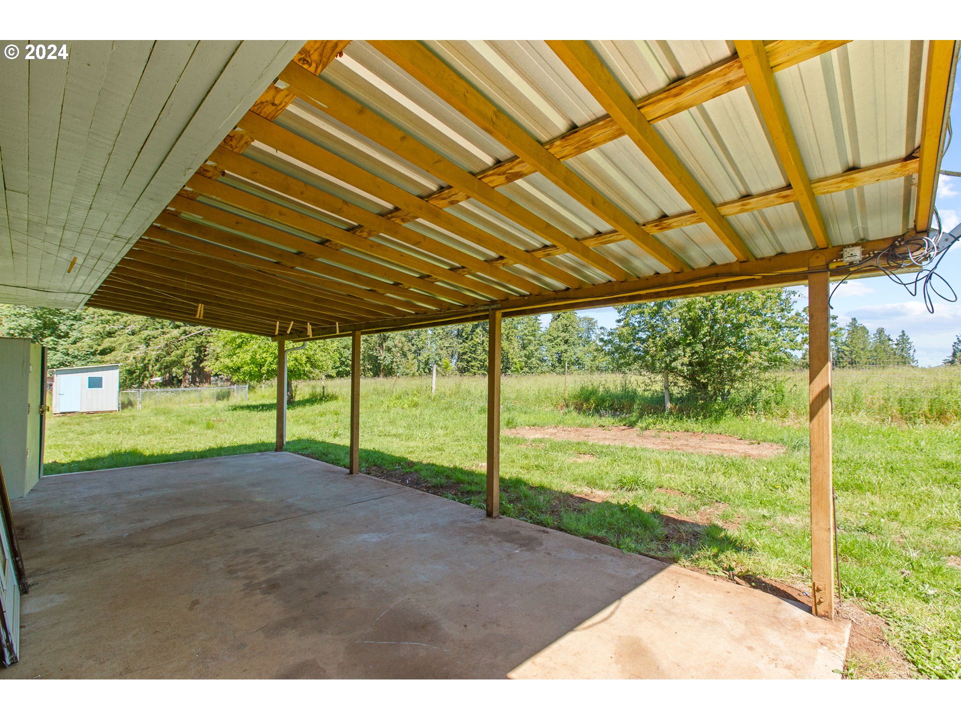 30806 South Oswalt Road Colton, OR 97017 - Photo 31 of 42 a view of a backyard with table and chairs under an umbrella