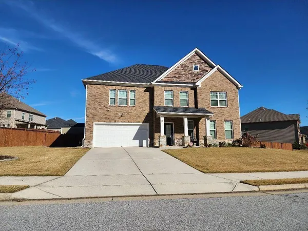a front view of a house with a yard