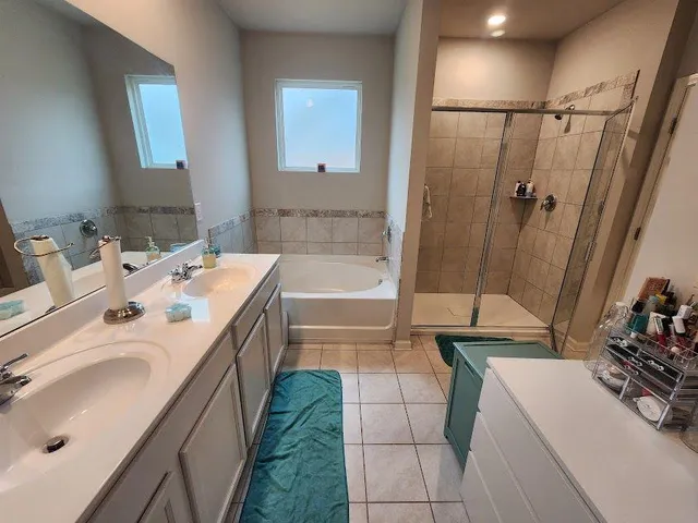 a bathroom with a sink a tub and a mirror