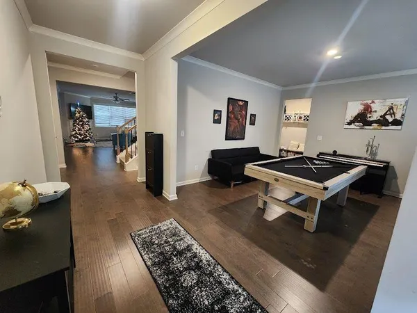 a living room with furniture and wooden floor
