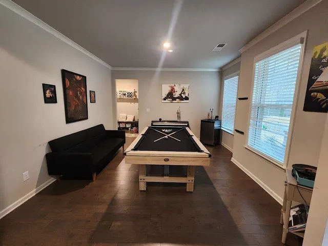 a living room with furniture gym equipment and a large window