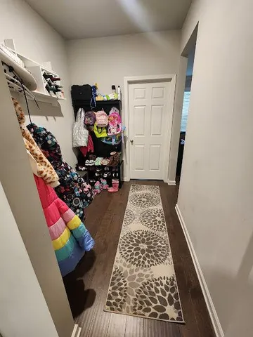 walk in closet with storage and utility