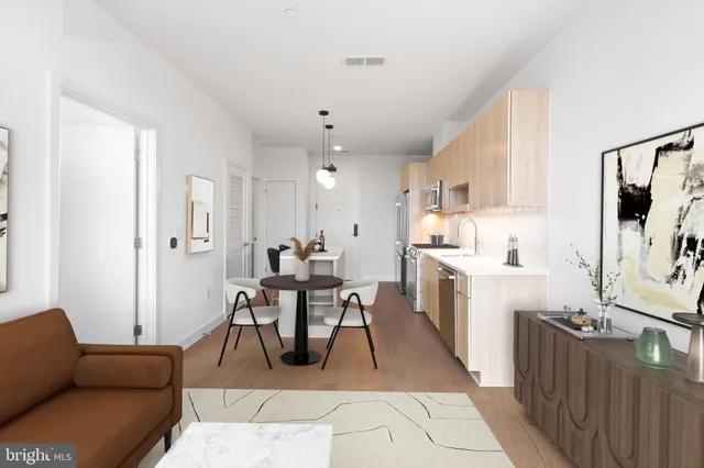 a living room with furniture a dining table and kitchen view