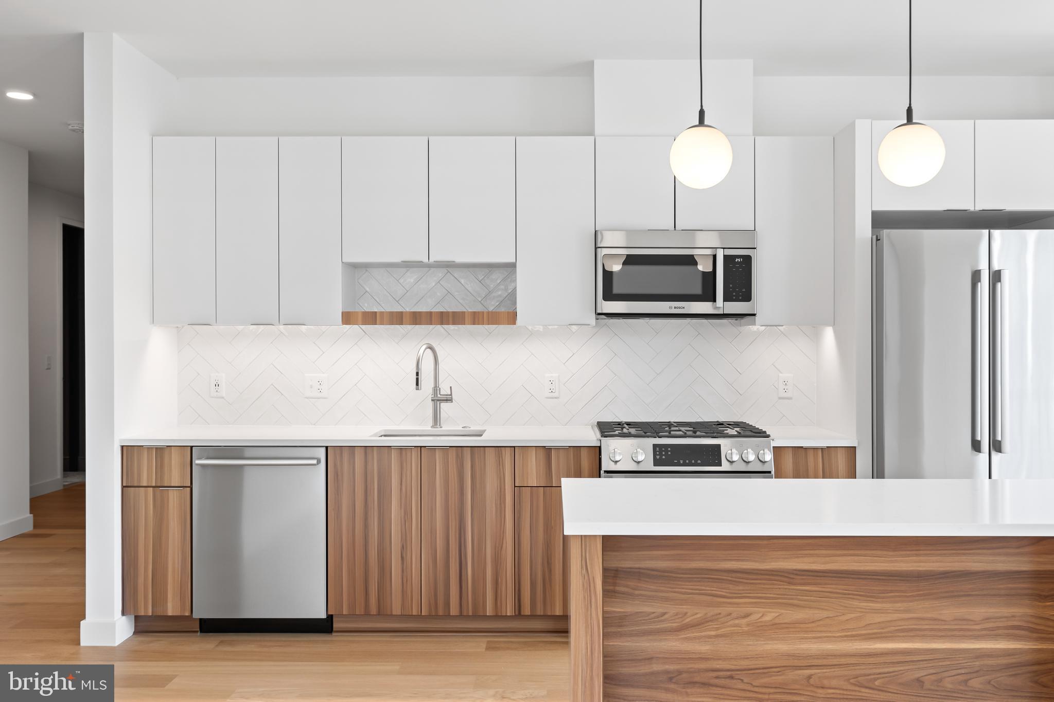 7175 12th Street Northwest, Unit 607 Washington, DC 20012 - Photo 2 of 25 a kitchen with cabinets and wooden floor