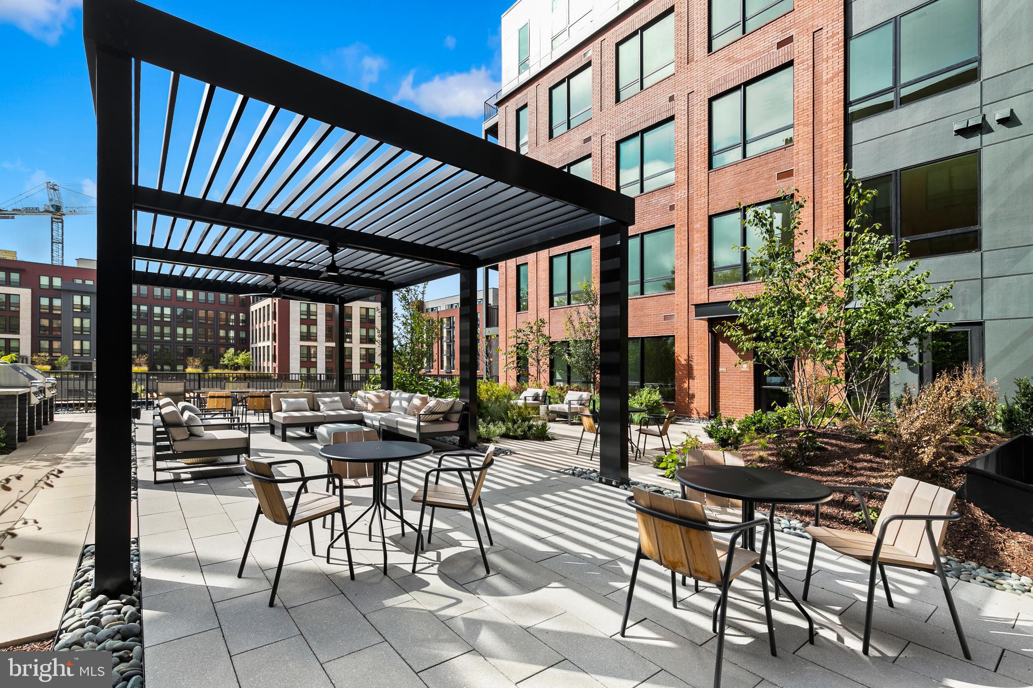 7175 12th Street Northwest, Unit 607 Washington, DC 20012 - Photo 8 of 25 a view of a patio with table and chairs and potted plants