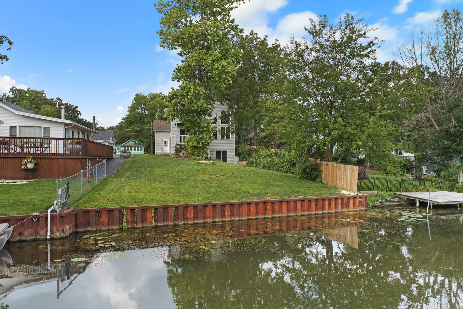 a view of a lake with a house in the background