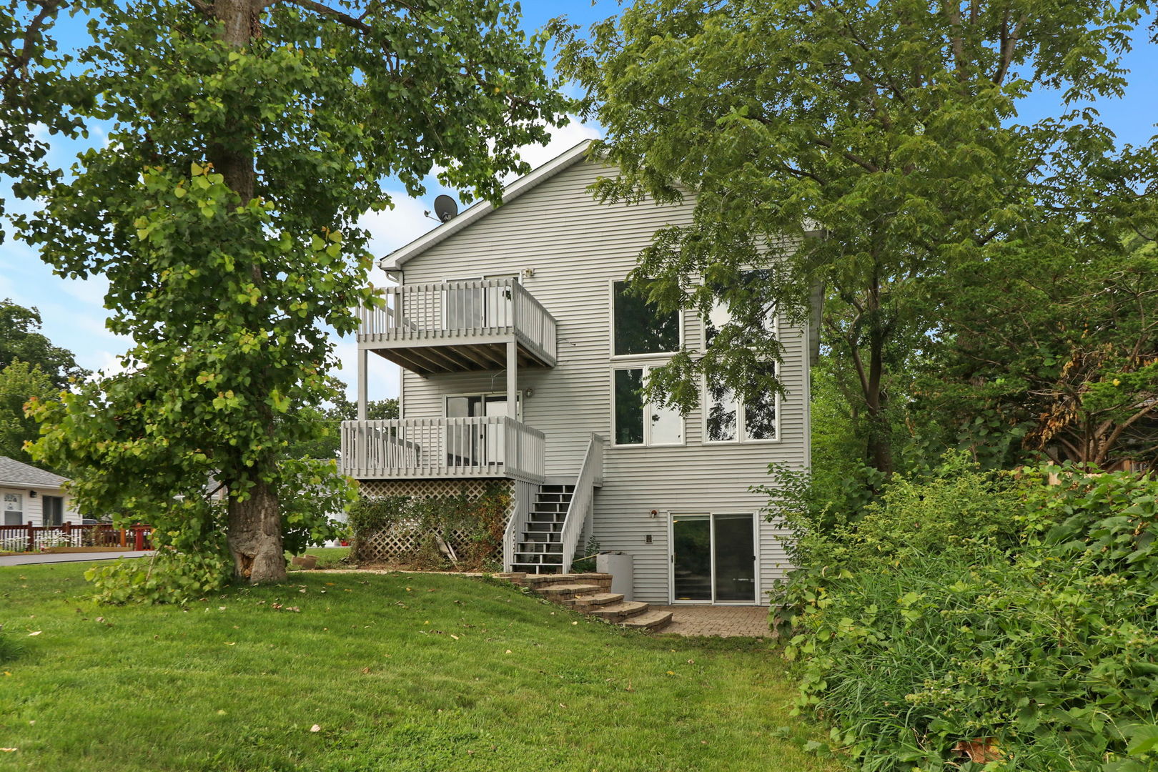 39 Rushmore Road Fox Lake, IL 60020 - Photo 2 of 38 a view of a big house with a big yard and large tree