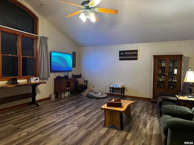 a living room with furniture a rug and a flat screen tv
