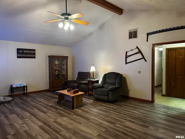 a living room with furniture and a ceiling fan