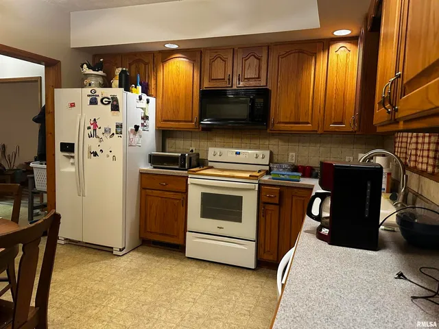 a kitchen with stainless steel appliances a stove a microwave and a refrigerator
