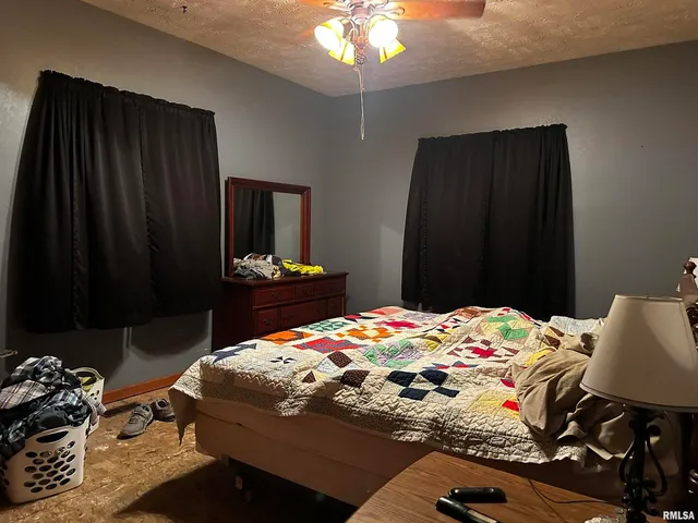 a bedroom with a bed and a dresser in it