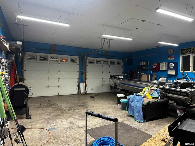 a room with gym equipment and a chandelier