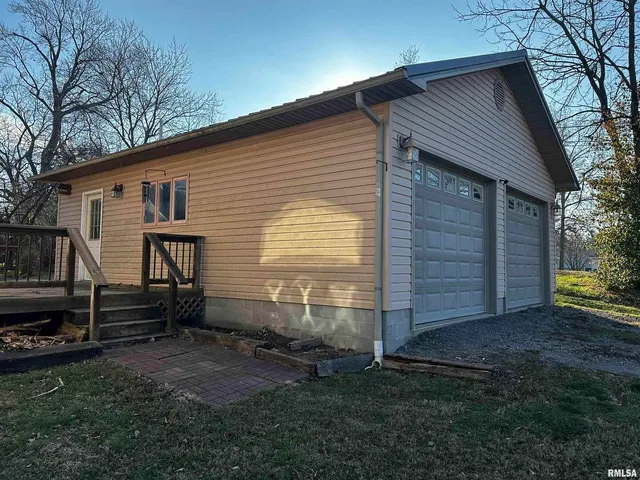 a view of backyard of house and wooden deck