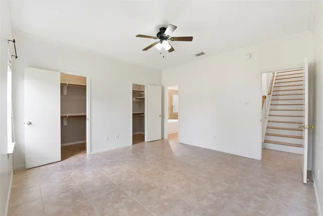 a view of an empty room with a ceiling fan