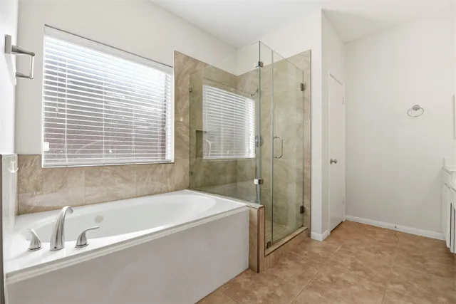 a bathroom with a bathtub and shower