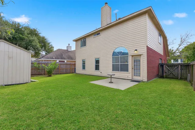 a view of a house with a backyard and porch