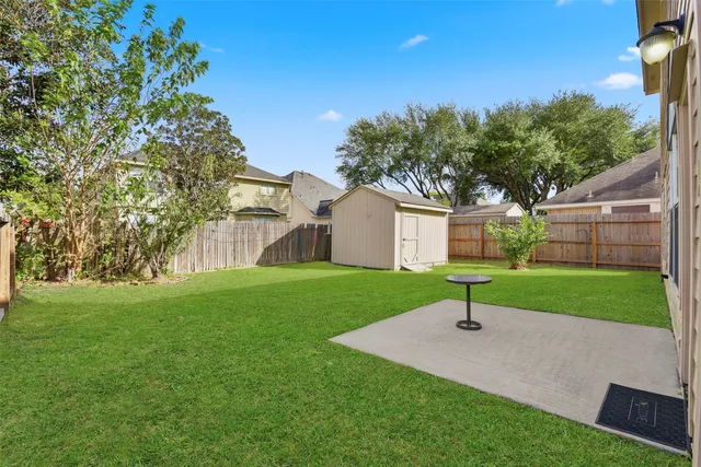 a view of a house with a yard and tree s
