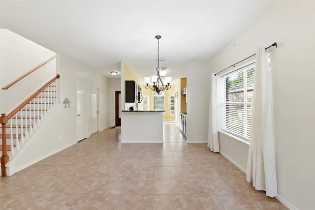 a view of a kitchen and an empty room