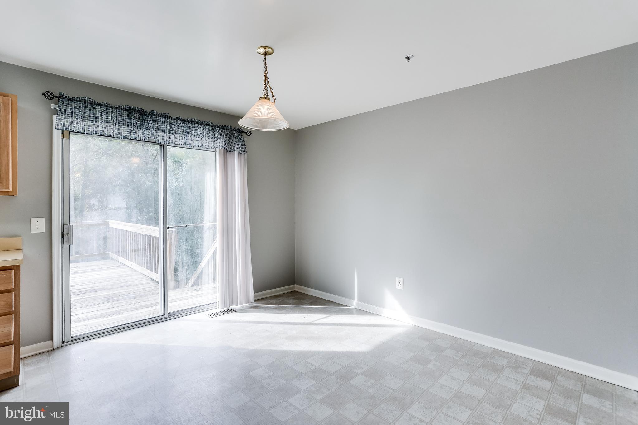 6514 Ridgeborne Drive Baltimore, MD 21237 - Photo 12 of 31 Table-Space Kitchen w/ Sliders to Deck