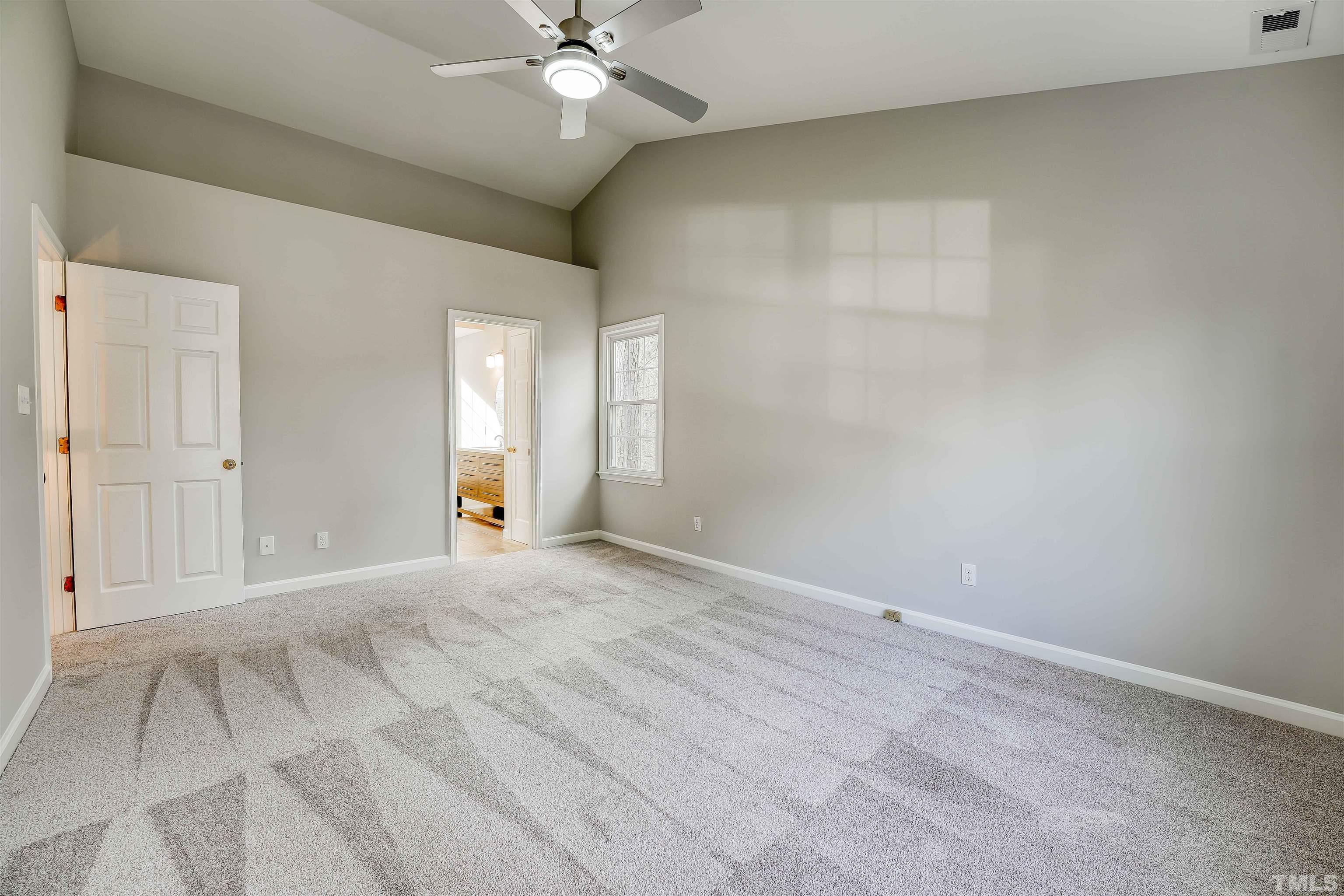 5516 Bridford Place Raleigh, NC 27613 - Photo 14 of 20 a view of an empty room with a chandelier fan