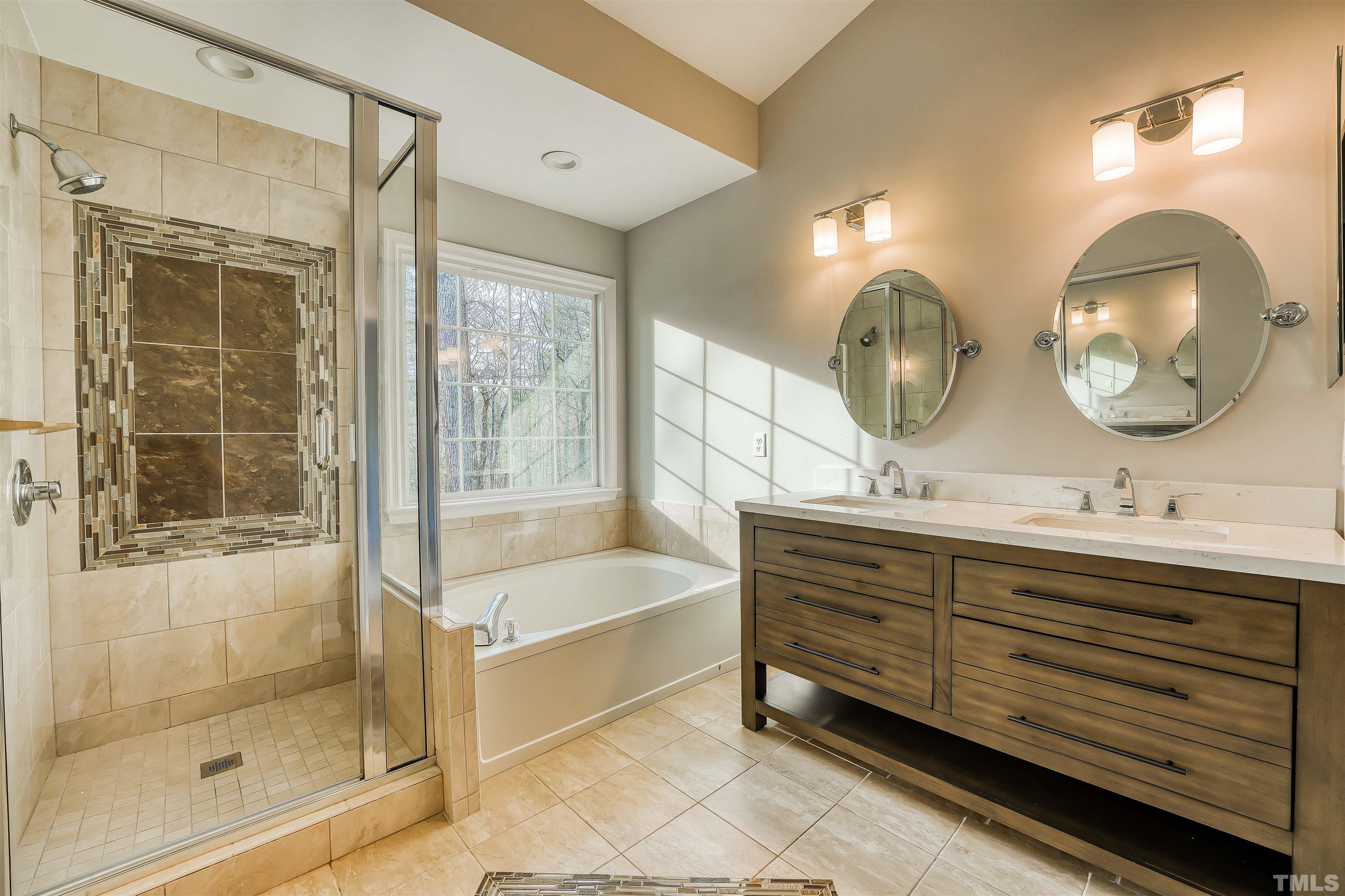 5516 Bridford Place Raleigh, NC 27613 - Photo 15 of 20 a bathroom with a double vanity sink mirror and bathtub