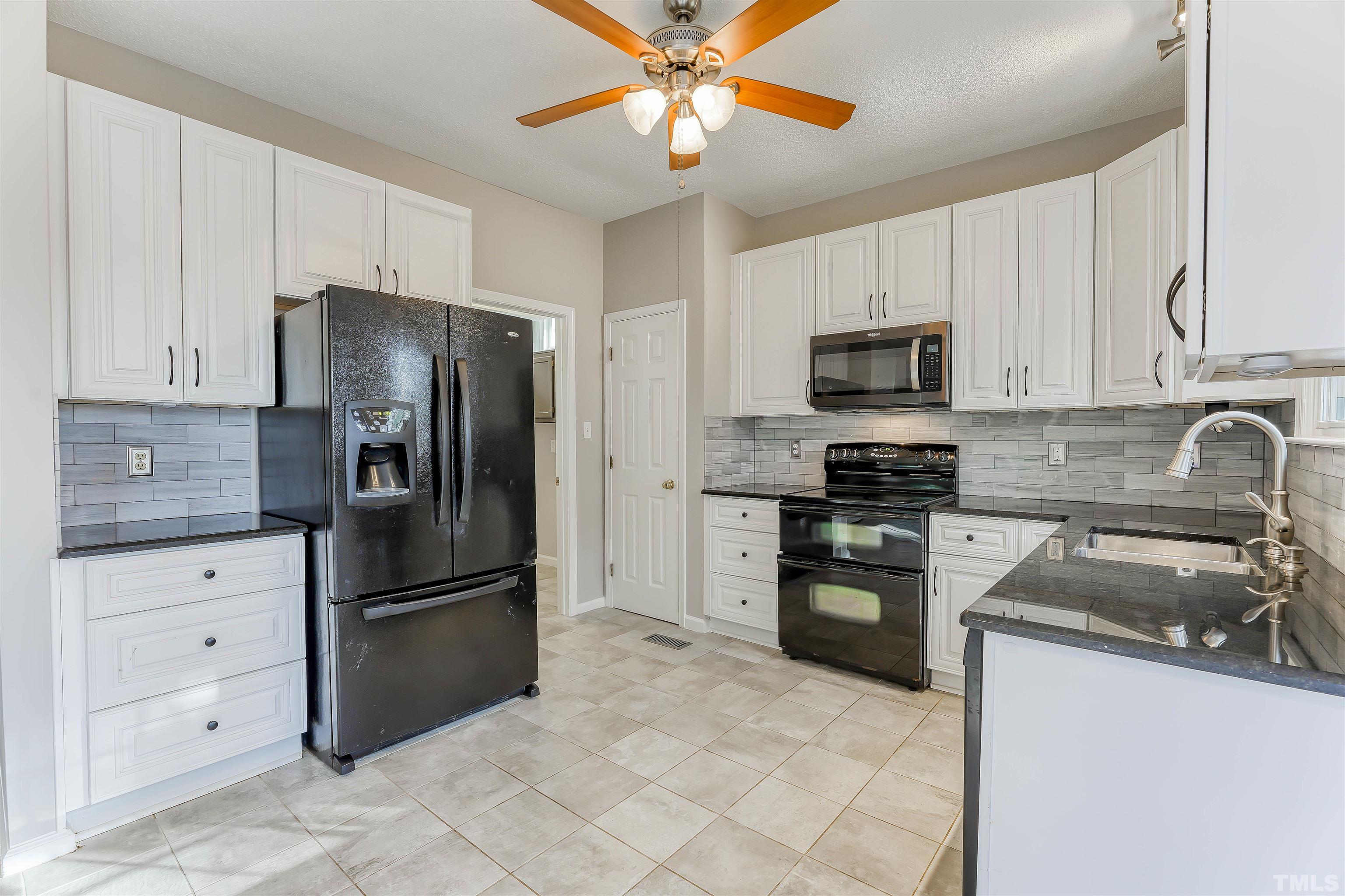 5516 Bridford Place Raleigh, NC 27613 - Photo 10 of 20 a kitchen with cabinets stainless steel appliances and a counter space