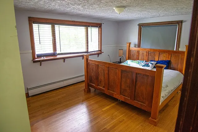 a bed room with a bed and a large window