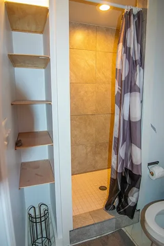 a view of a livingroom with furniture a fireplace and wooden floor