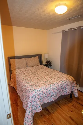 a bedroom with a bed and a mirror