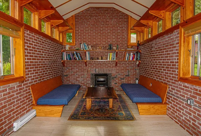 a view of wooden door with a bench in front of house