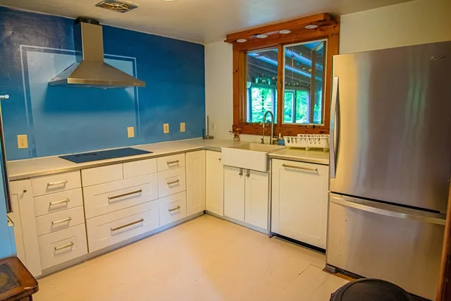 a kitchen with white cabinets and white appliances